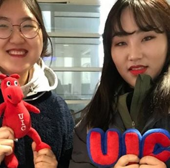 New UIC Global students holding UIC stuffed toys. 