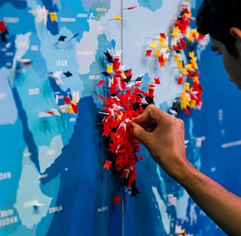 A UIC international student presses a pin into his home country of India on a map 