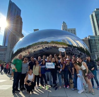 Students standing in front of the Bean
                  