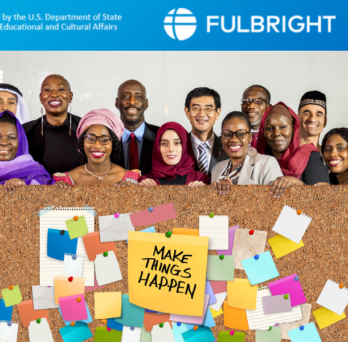 A group of international people standing under the Fulbright logo
                  