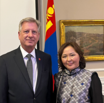 Dr Neal McCrillis standing on the left and Mongolia Consul General Battsetseg Tuvshintugs standing on the right 